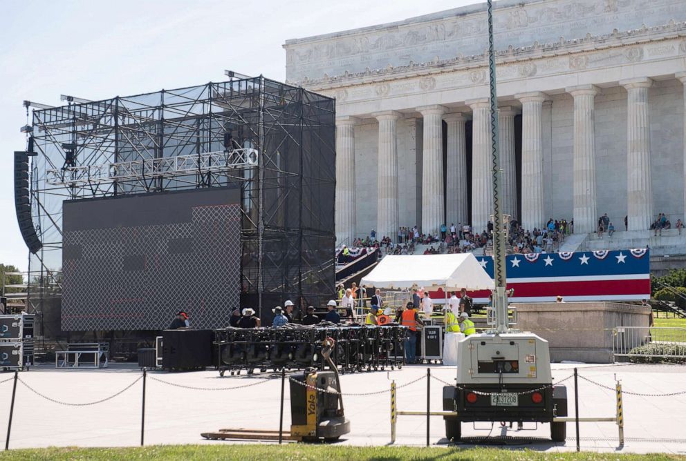 PHOTO: Workers build a stage and bleachers for the Salute to America Fourth of July event at the Lincoln Memorial on the National Mall in Washington, DC, July 1, 2019.