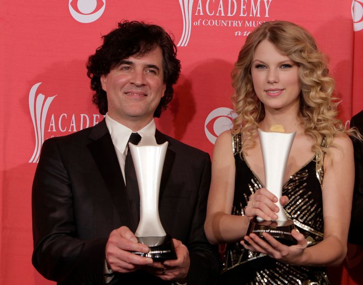 In this April 5, 2009 file photo, producer Scott Borchetta, left, and Swift pose with the Album of the Year award at the 44th
