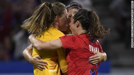 United States goalkeeper Alyssa Naeher is mobbed by teammates after her crucial penalty save.