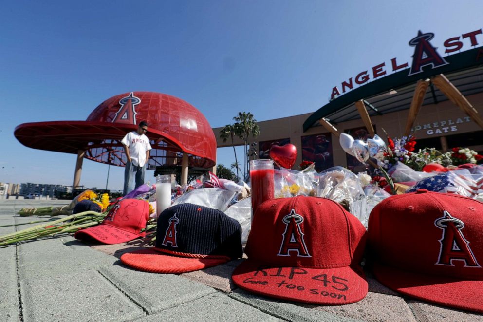 PHOTO: Angel Lozano looks over at a memorial as he give his condolences for Los Angeles Angels pitcher Tyler Skaggs outside Angel Stadium in Anaheim, Calif., on July 2, 2019.