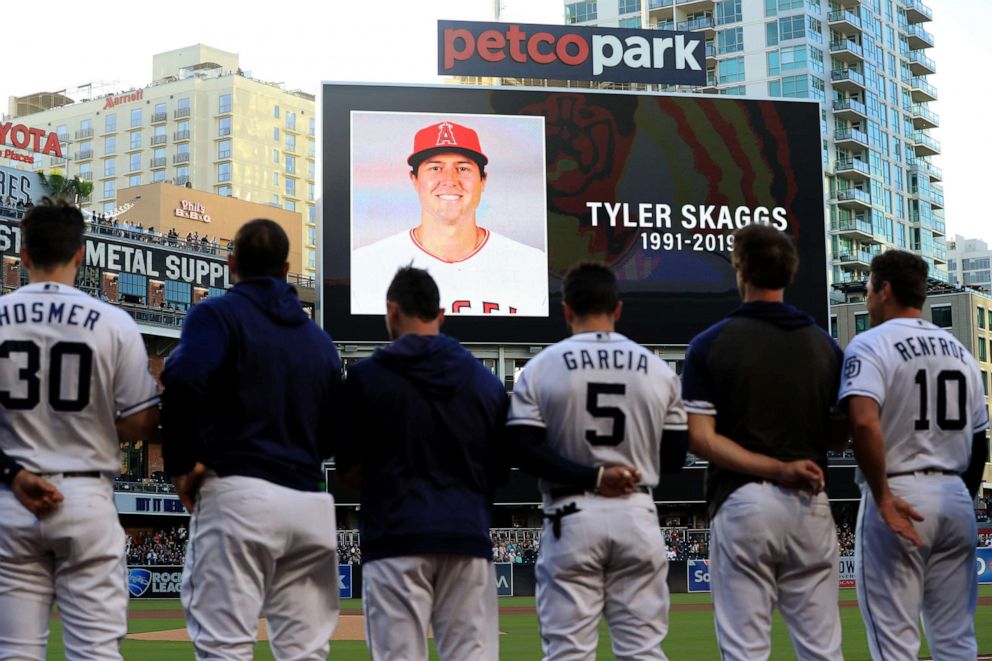 PHOTO: Players for the San Diego Padres and San Francisco Giants stand during a moment of silence for pitcher Tyler Skaggs of the Los Angeles Angels of Anaheim at PETCO Park on July 01, 2019, in San Diego.
