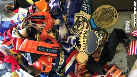 A pile of Meza&#39;s racing medals rests on a coffee table at home.