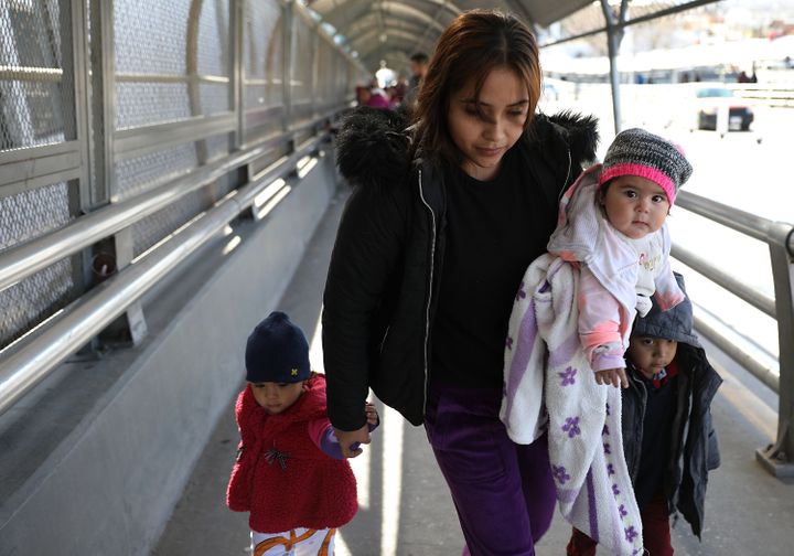 Daniela Serrano and her baby, Maria de Jesus Cabrera, from Michoacan, Mexico cross the Paso Del Norte Port of Entry bridge to