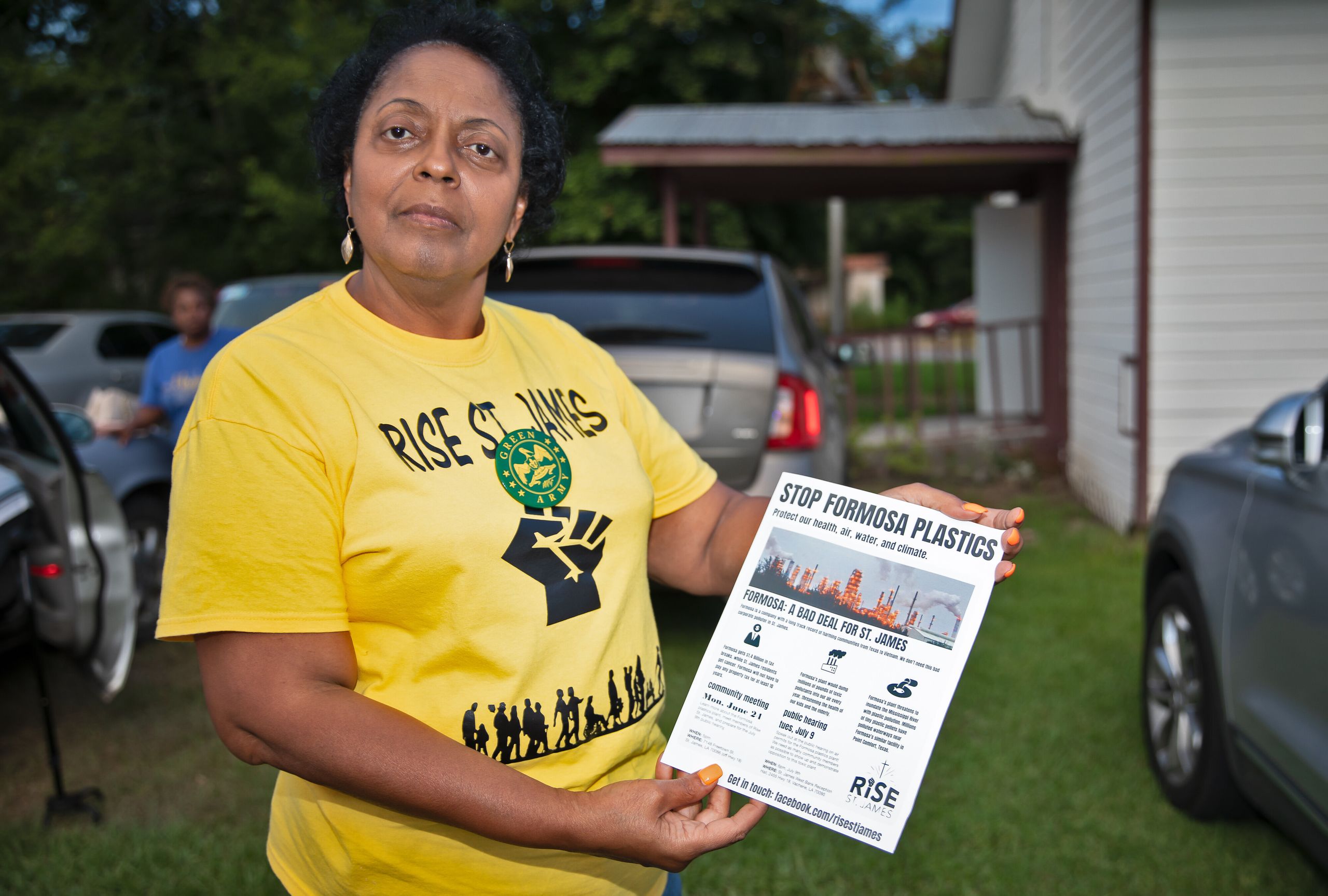 Sharon Lavinge founder of RISE St. James in front of the Mt. Triumph Baptist Church with a flyer about the proposed Formosa p