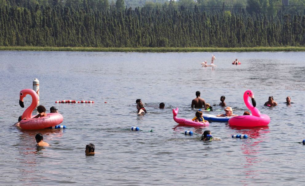 PHOTO: Children play with inflatable flamingos and other creatures at Goose Lake on July 5, 2019, in Anchorage, Alaska.