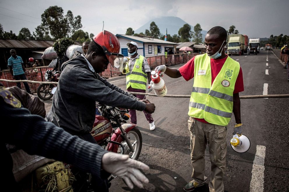 PHOTO: A driver gets his hands washed at an Ebola screening station on the road between Butembo and Goma, July 16, 2019 in the Democratic Republic of Congo.