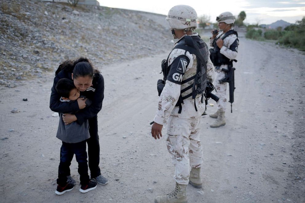 PHOTO: Guatemalan migrant Lety Perez embraces her son Anthony while asking to members of the Mexican National Guard to let them cross into the United States, as seen from Ciudad Juarez, Mexico July 22, 2019