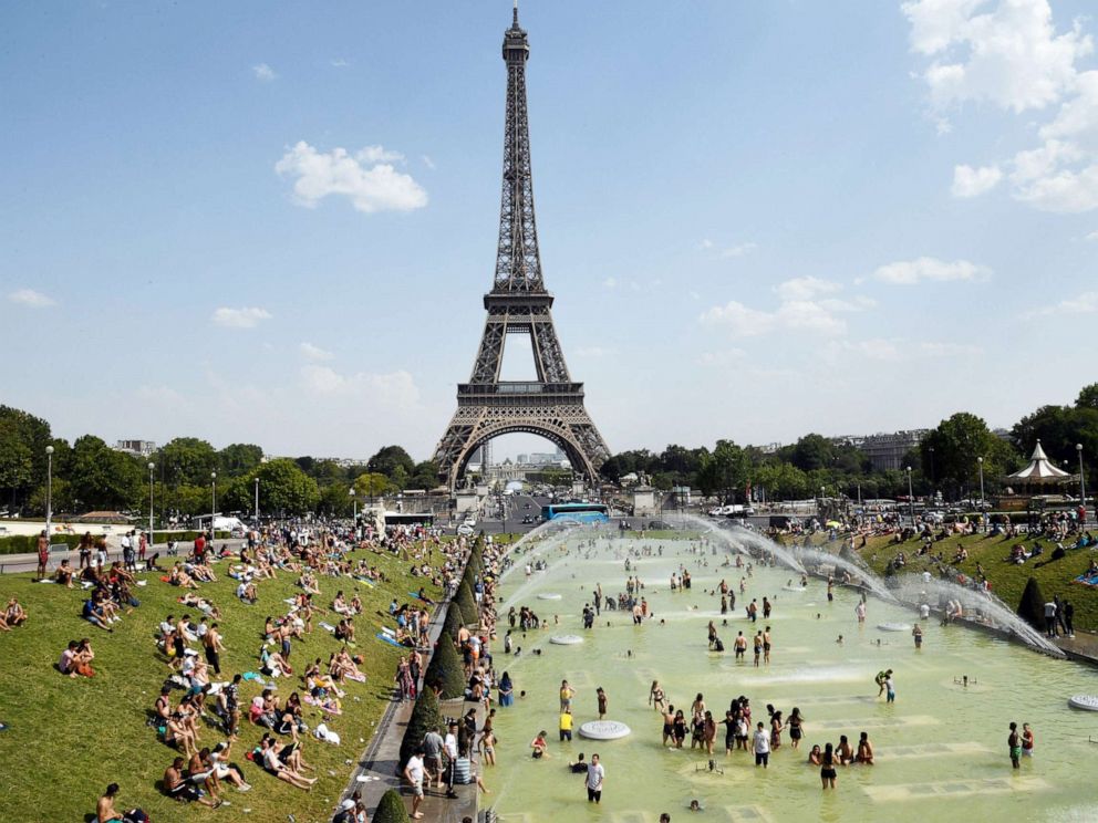 PHOTO:People cool off and sunbathe by the Trocadero Fountains next to the Eiffel Tower in Paris, on July 25, 2019 as a new heatwave hits the French capital.