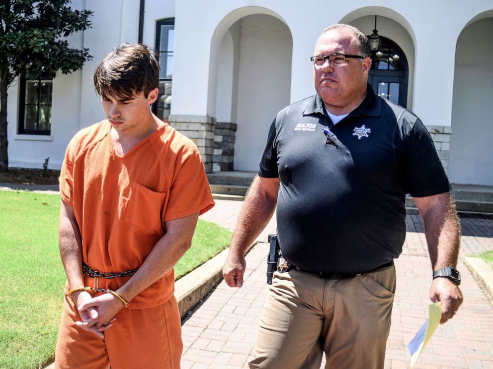 PHOTO: Brandon Theesfeld is led from the Lafayette County Courthouse in Oxford, Miss., on July 23, 2019, by Maj. Alan Wilburn, after being arraigned in connection with the death of 21-year-old University of Mississippi student Alexandria Ally Kostial.