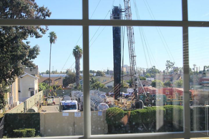 The Jefferson Boulevard drill site seen through a window of a neighboring home. In some places, the site is just feet from oc