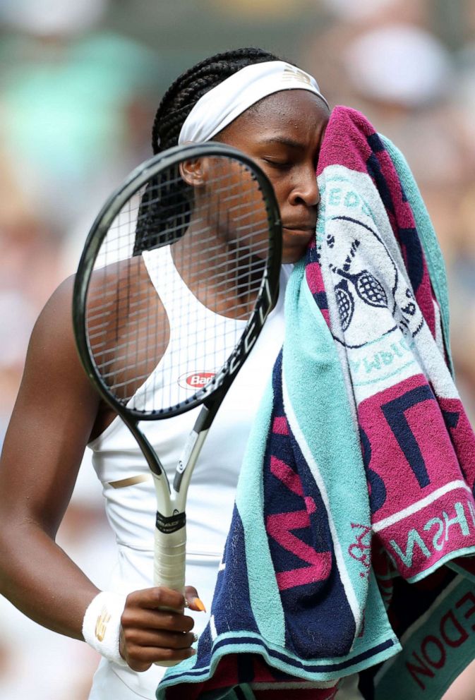 PHOTO: Cori Gauff wipes her face following her defeat in her Ladies Singles fourth round match at Wimbledon to Romanias Simona Halep, in London, July 8, 2019.