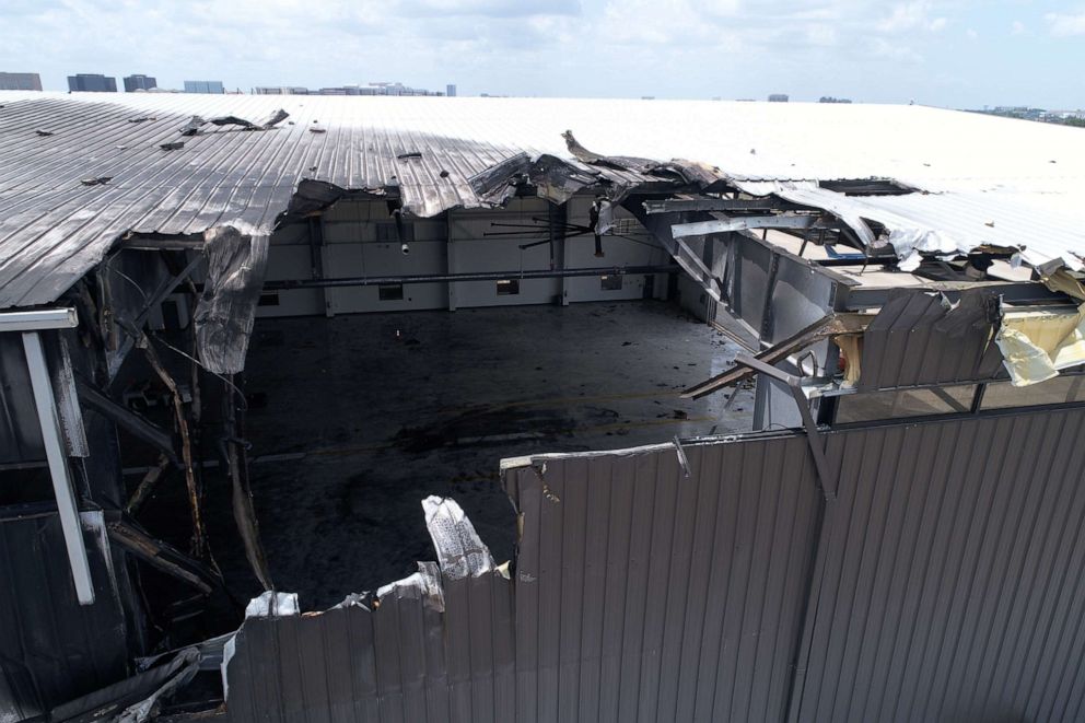 PHOTO: The charred damage to an airport hangar is seen after a twin-engine plane crashed, killing 10, on June 30, 2019, outside Dallas, Texas.