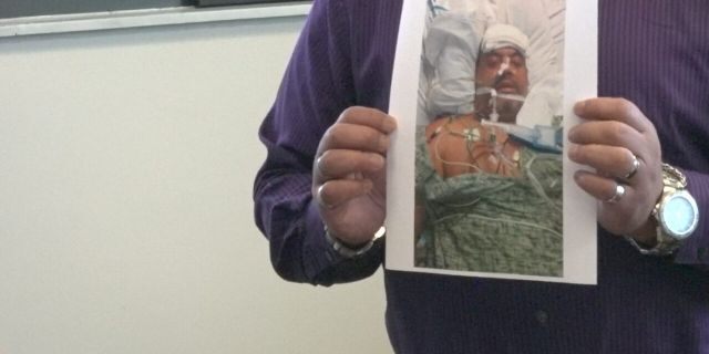 Martinez shows a picture of himself after the emergency surgery at the hospital, after his liposuction procedure