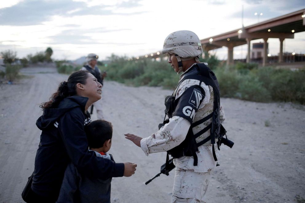 PHOTO: Guatemalan migrant Lety Perez embraces her son Anthony while asking a member of the Mexican National Guard to let them cross into the United States, as seen from Ciudad Juarez, Mexico July 22, 2019.