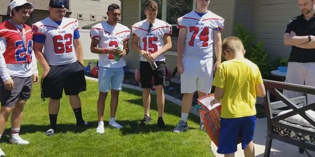  Christian Larsen opened a gift from Nampa High School Football players who attended his birthday party.