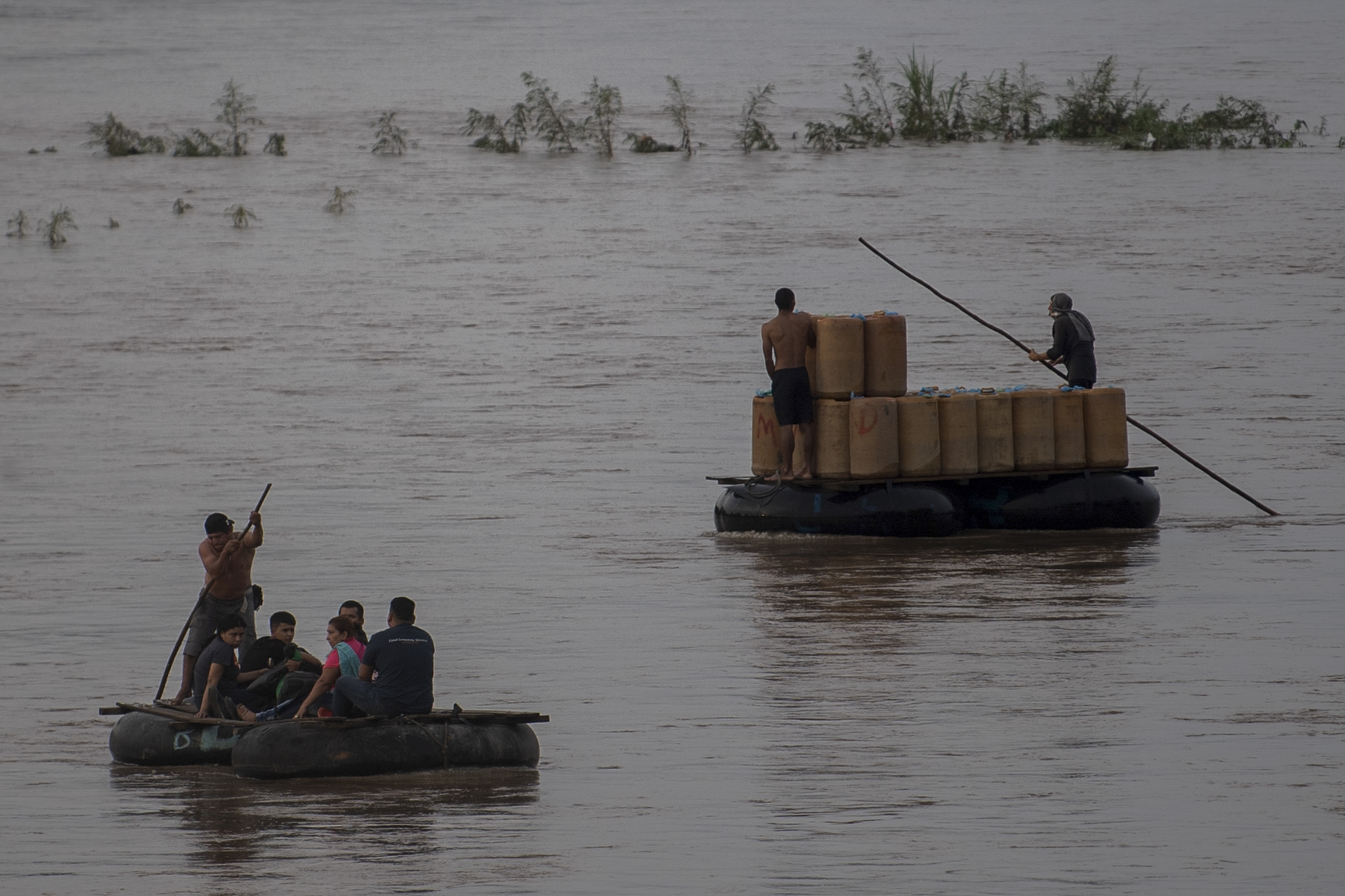 Locals use a makeshift raft to illegally cross the Suchiate river from Ciudad Hidalgo in Chiapas State, Mexico, to Tecun Uman in Guatemala, on June 10, 2019.