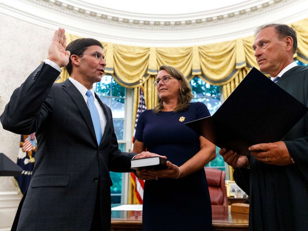 PHOTO: Mark Esper, left, is sworn in as the Secretary of Defense by Supreme Court Justice Samuel Alito, right, as is wife Leah Esper holds the Bible, during a ceremony in the Oval Office at the White House in Washington, July 23, 2019.