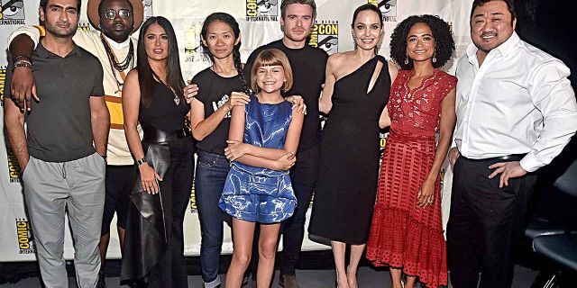 Kumail Nanjiani, Brian Tyree Henry, Salma Hayek, director Chloe Zhao, Lia McHugh, Richard Madden, Angelina Jolie, Lauren Ridloff and Don Lee of Marvel Studios' "The Eternals" pose for a photo at the San Diego Comic-Con International 2019 Marvel Studios Panel in Hall H on July 20, 2019.