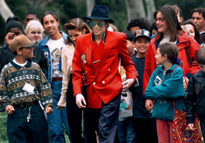 In this April 18, 1995, file photo, pop star Michael Jackson and Lisa Marie Presley, behind him at left, walk with children that were invited guests at his Neverland Ranch home in Santa Ynez, Calif. The co-executor of Jackson's estate says he's confident the late superstar's supporters will be able to protect his legacy and brand in the wake of HBO’s 