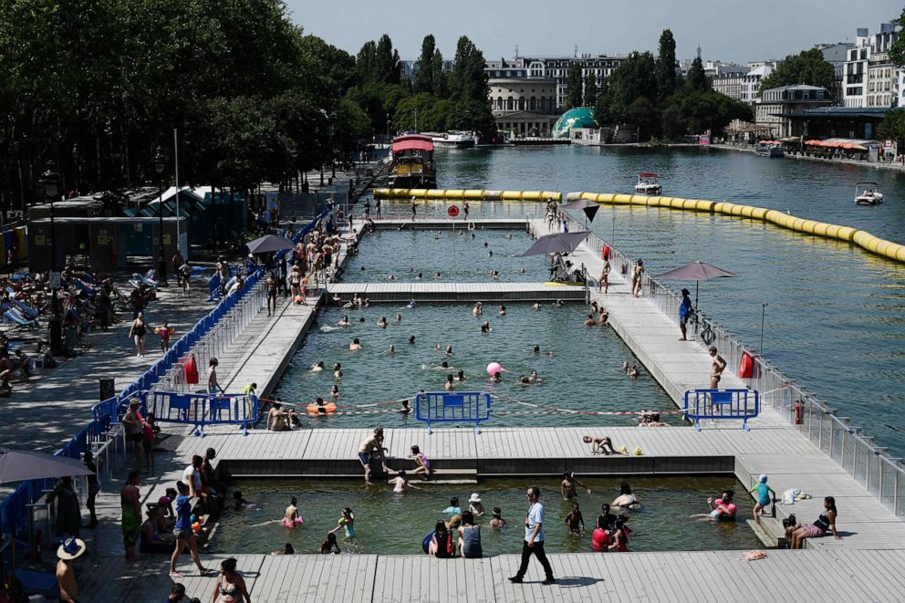 PHOTO: People cool off at floating pools set up on the Ourcq canal in Paris on July 25, 2019, as a new heatwave hits Europe.