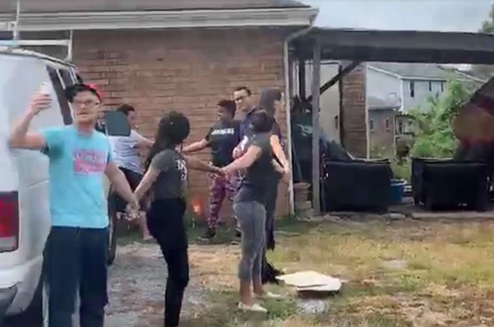 PHOTO: Neighbors formed a human chain on Monday, July 22 to prevent the arrest of a man outside his home near Nashville. 