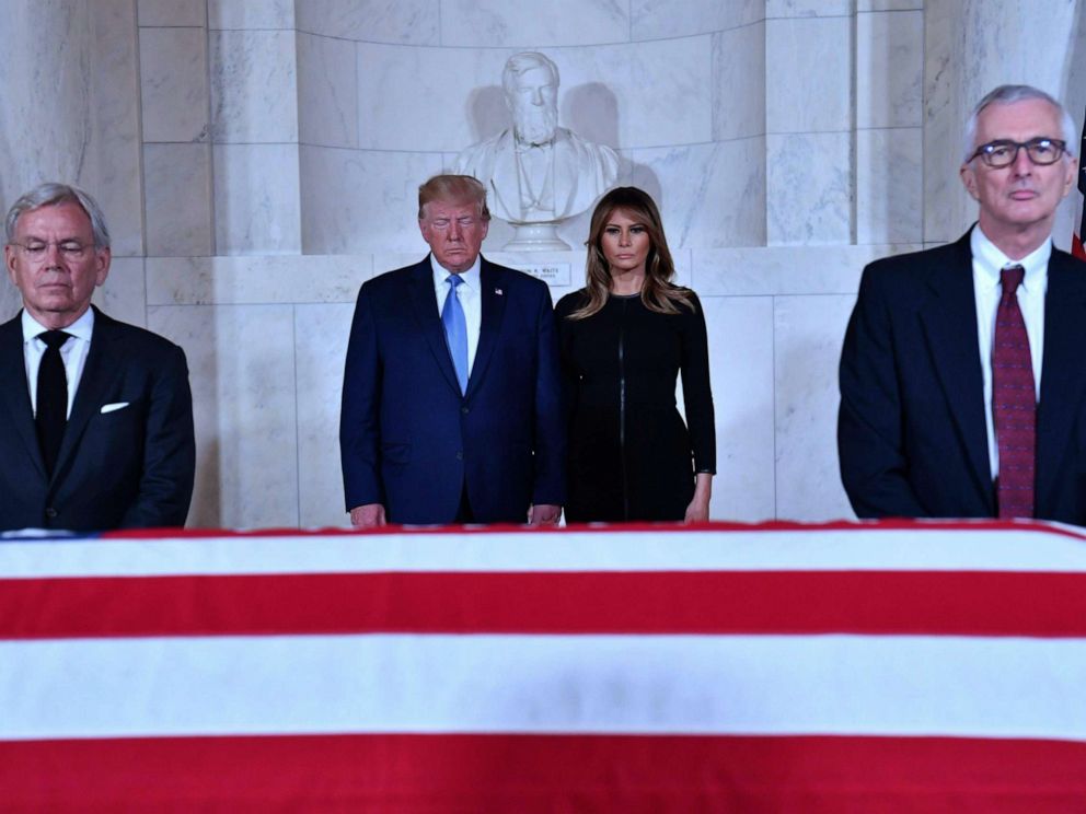 PHOTO: President Donald Trump and first lady Melania Trump pay their respects before the flag-draped casket of late Supreme Court Justice John Paul Stevens in the Great Hall of the Supreme Court in Washington D.C., July 22, 2019. 