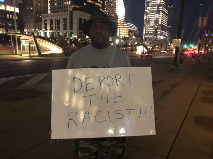 A 38-year-old protester named Brandon holds a sign near U.S. Bank Arena after a Trump rally in Cincinnati on Aug. 1, 2019.