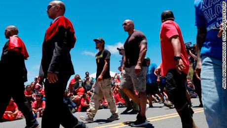 Actor Dwayne &quot;The Rock&quot; Johnson, third from right, walks with telescope protesters during his visit to the base of Mauna Kea.