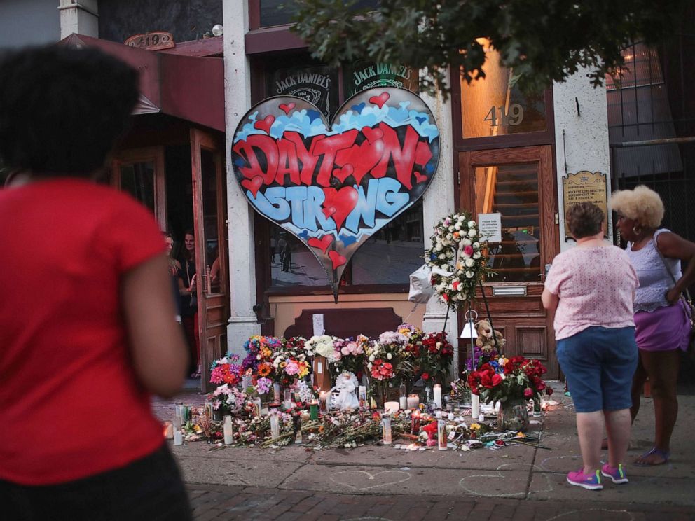 PHOTO: People congregate around a memorial to those killed in Sunday mornings mass shooting on Aug. 6, 2019 in Dayton, Ohio.