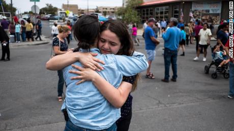 CNN reporter Nicole Chavez hugs Adria Gonzalez, a survivor of the mass shooting in El Paso, across from the Walmart where the shooting took place. 