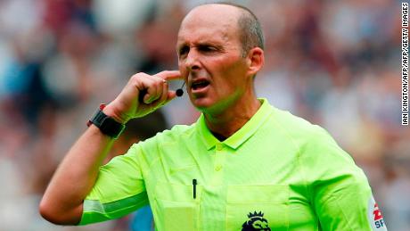 Referee Mike Dean consults the video assistant referee