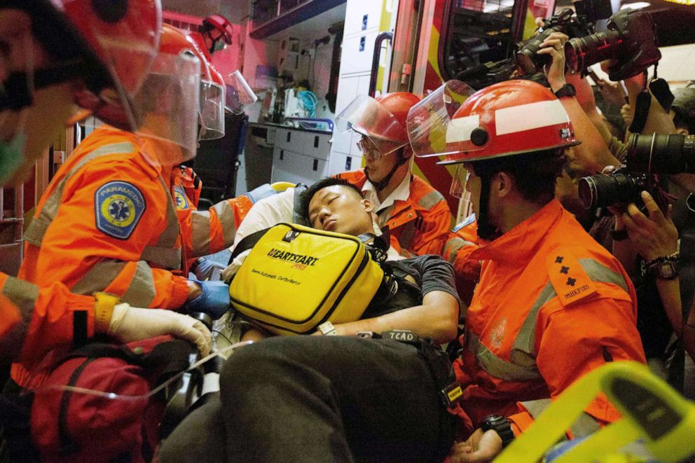 PHOTO: A man who protesters reportedly suspected of being an undercover Chinese policeman is taken away by medics at Hong Kong International Airport, Aug. 13, 2019.