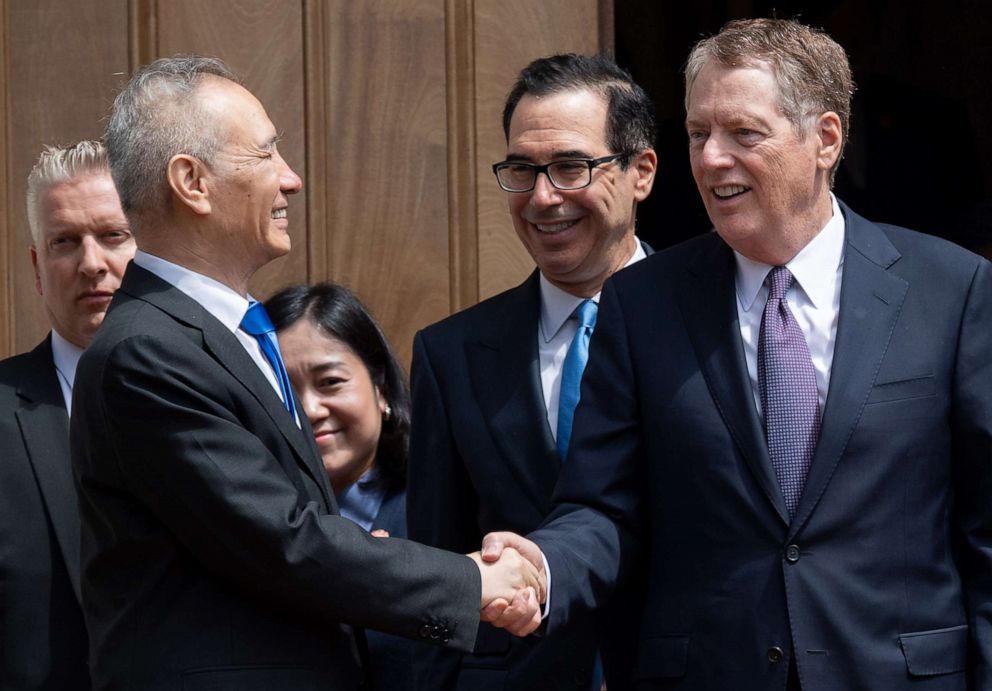 PHOTO: Chinese Vice Premier Liu He (L) shakes hands with US Trade Representative Robert Lighthizer (R) alongside US Treasury Secretary Steven Mnuchin (C) after trade negotiations in Washington, DC, May 10, 2019.