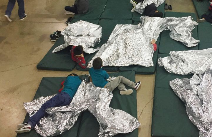 In this Sunday, June 17, 2018, file photo provided by U.S. Customs and Border Protection, people who've been taken into custo