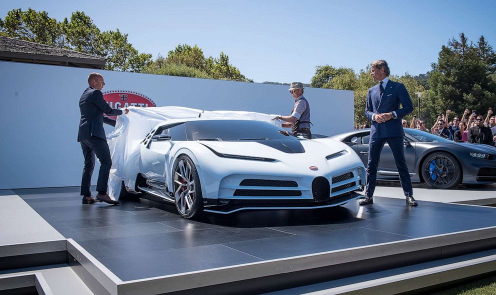 PHOTO: Stephan Winkelmann, president of Bugatti Automobiles SAS, right, watches the unveiling of the companys limited-edition Centodieci supercar in Carmel, Calif., Aug. 16, 2019.