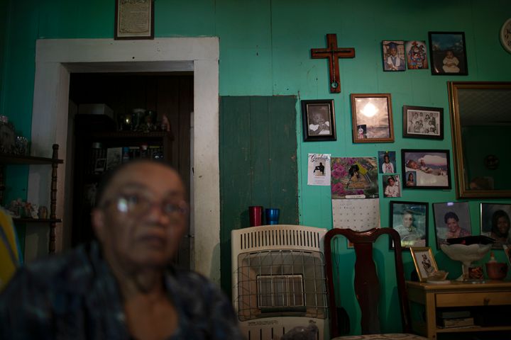Lou Alice Bolden with a crucifix and framed photographs in her home in Greenwood, Miss., Saturday, June 8, 2019. Known as "Mi