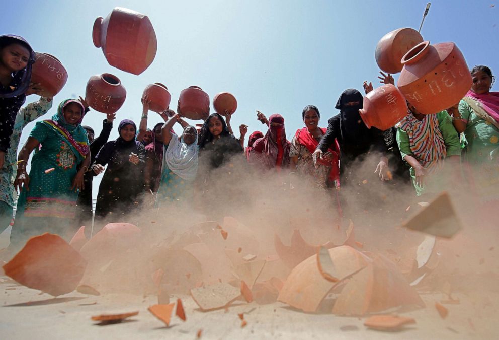 PHOTO: Women throw earthen pitchers onto the ground in protest against the shortage of drinking water outside the municipal corporation office in Ahmedabad, India, May 16, 2019.