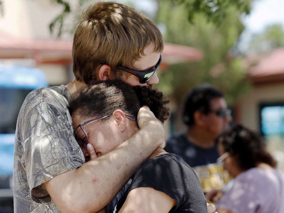 PHOTO:A man comforts a woman who was in the freezer section of a Walmart during a shooting incident, in El Paso, Texas, Aug. 03, 2019.