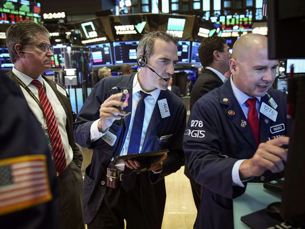 PHOTO: Traders and financial professionals work on the floor of the New York Stock Exchange (NYSE) on Aug. 6, 2019 in the Brooklyn borough of New York City.