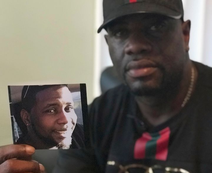 In this Aug. 7, 2018, file photo, Michael McGlockton holds a photo of his son, Markeis McGlockton, in Clearwater, Florida.