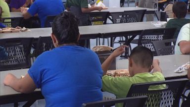 PHOTO: A women and young child eat at the cafeteria of the Immigration and Customs Enforcement family detention center in Dilley, Texas, on August 23, 2019. 