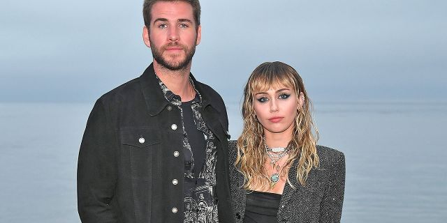 Miley Cyrus and Liam Hemsworth attend a Saint Laurent fashion show in Malibu in June 2019. The couple announced in August 2019 that they'd separated after eight months of marriage.