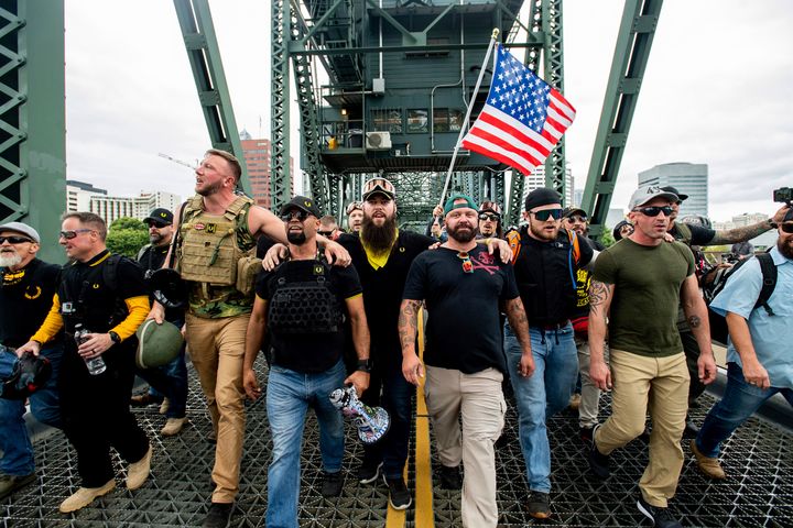 Members of the Proud Boys and other right-wing demonstrators march across the Hawthorne Bridge during a rally in Portland, Or