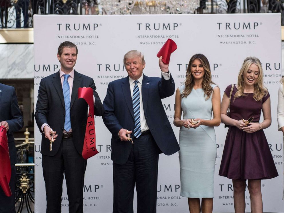 PHOTO: Donald Trump, accompanied by, from left, Donald Trump Jr., Eric Trump, Trump, Tiffany Trump, Melania Trump and Ivanka Trump, holds up a ribbon during the grand opening ceremony of the Trump International Hotel in Washington, Oct. 26, 2016.