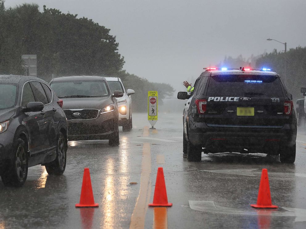 PHOTO: A Highland Beach police officer sits in his vehicle to check ids of people in cars as he only allows residents to enter the Highland Beach area as Hurricane Dorian continues to make its way toward the Florida coast, Sept. 2, 2019.