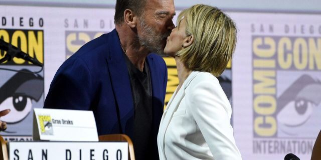 Arnold Schwarzenegger, left, and Linda Hamilton kiss at the "Terminator: Dark Fate" panel on day one of Comic-Con International on Thursday, July 18, 2019, in San Diego. (Photo by Chris Pizzello/Invision/AP)