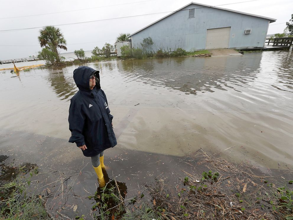PHOTO: Cheryl Conners looks over flood waters surrounding Langs Marina near her home during Hurricane Dorian, Sept. 4, 2019, in St. Marys, Ga.