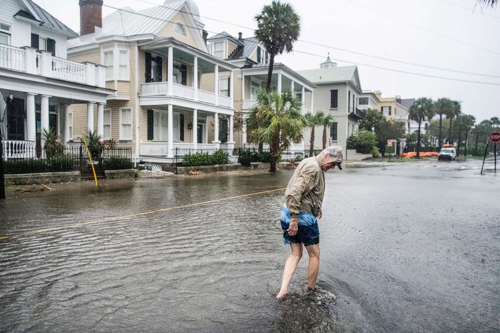 PHOTO: Bill Olesner walks down South Battery Street while cleaning debris from storm drains on Sept. 5, 2019 in Charleston, S.C. as Hurricane Dorian brings wind and rain to the area.