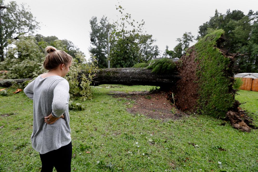 PHOTO: Kelsey Myers looks at an overturned tree in her front yard in Summerville, S.C., after Hurricane Dorian passed by, Sept. 5, 2019, in Summerville, S.C.