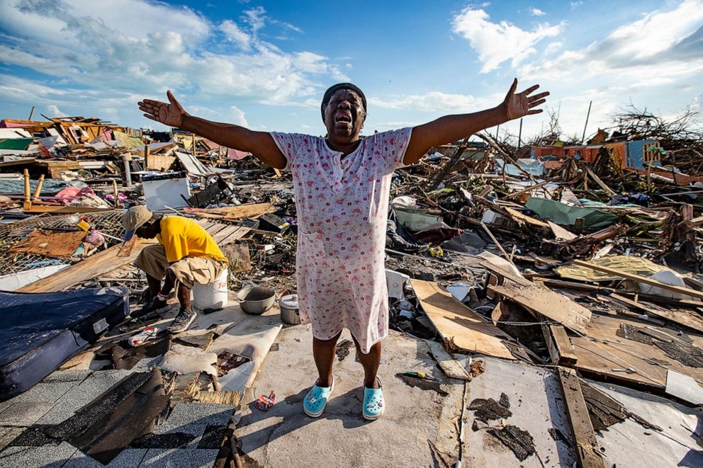 PHOTO: Aliana Alexis, of Haiti, stands on the concrete slab of what is left of her home after destruction from Hurricane Dorian in an area called The Mud at Marsh Harbour in Great Abaco Island, Bahamas, Sept. 5, 2019.